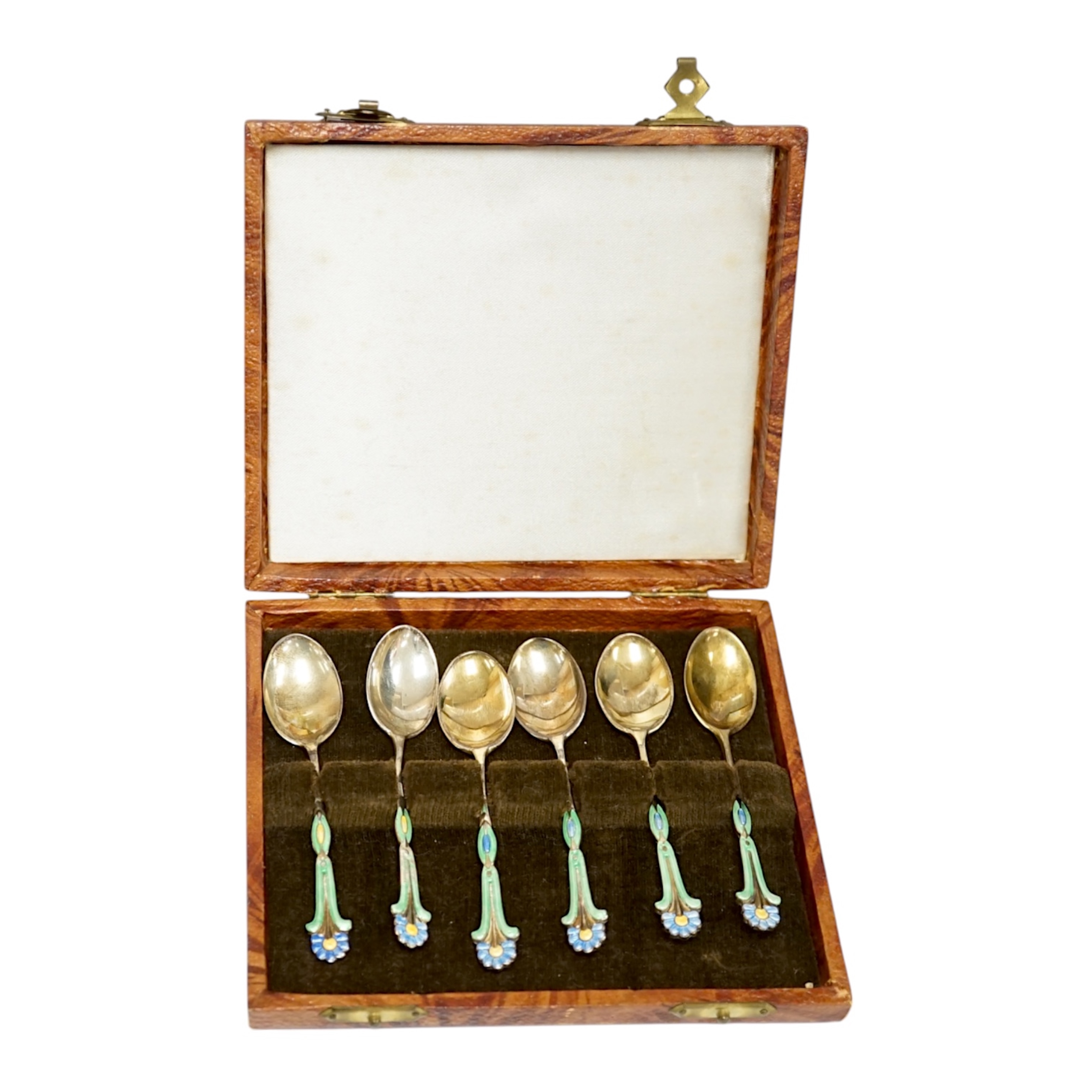 A cased harlequin set of six George VI silver gilt and three colour enamel set coffee spoons, Turner & Simpson, Birmingham, 1940,42 & 48, 89mm, enamel a.f. Condition - poor to fair